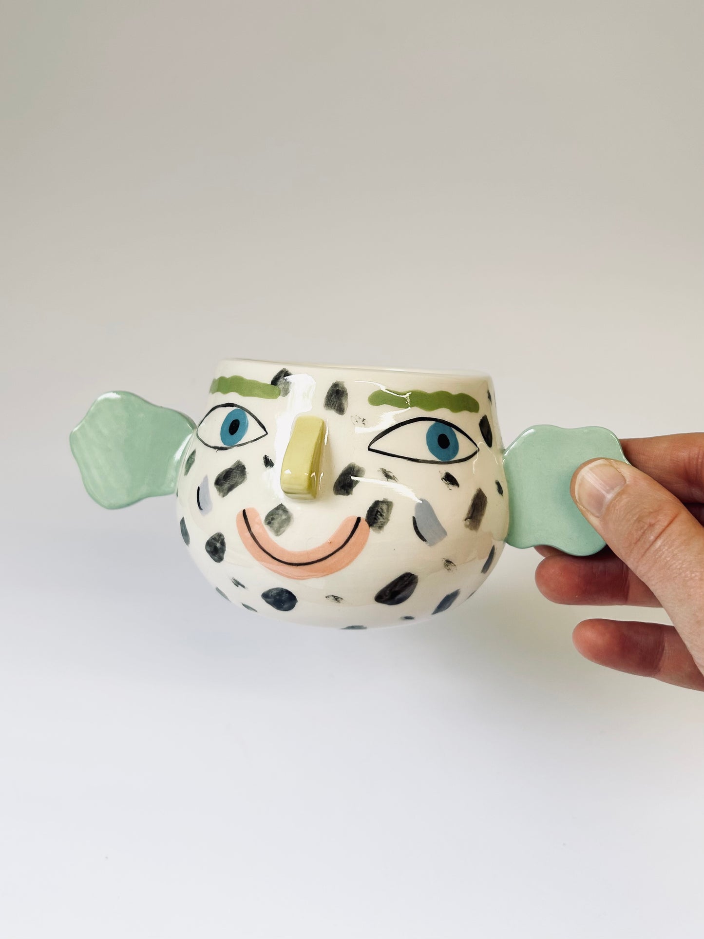 Spotty face pot